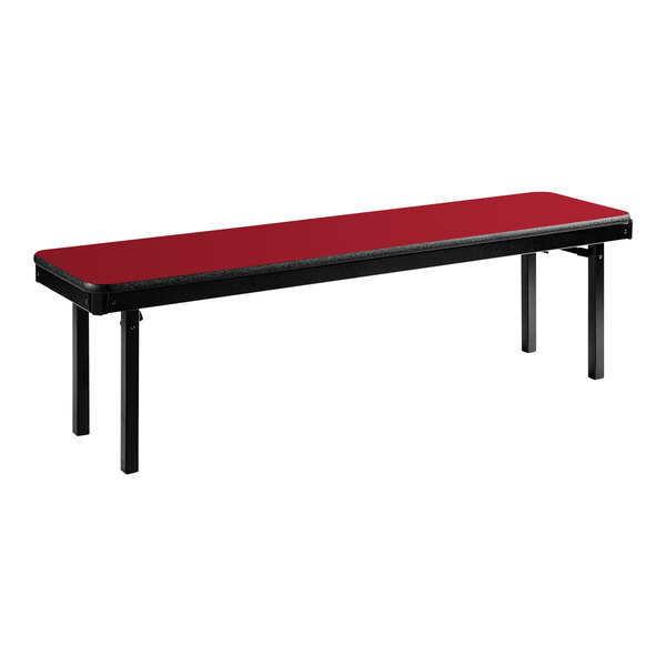 A red National Public Seating folding bench with a black T-mold edge.