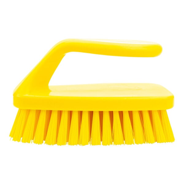 A yellow Carlisle Sparta hand scrub brush with a handle and bristles.