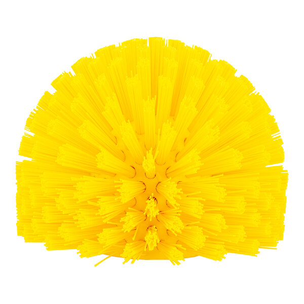 A Carlisle yellow plastic brush with many bristles on a round end.
