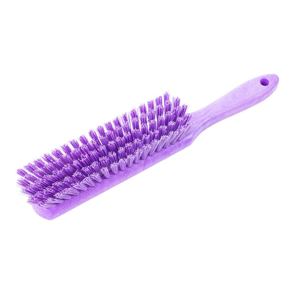 A close-up of a Carlisle purple counter brush with white bristles.