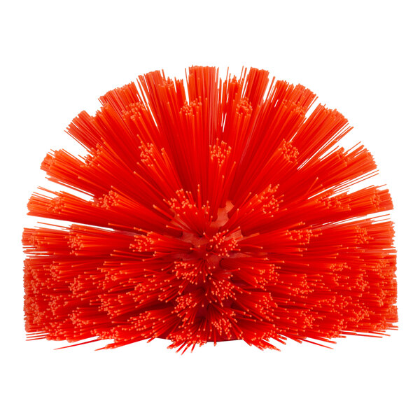 A red plastic Carlisle brush with many small sticks on top.