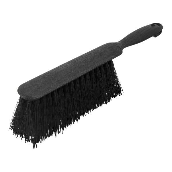 A black Carlisle counter brush with a handle.