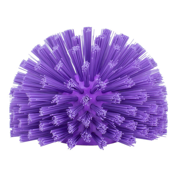 A purple round brush with many bristles and a handle on top.