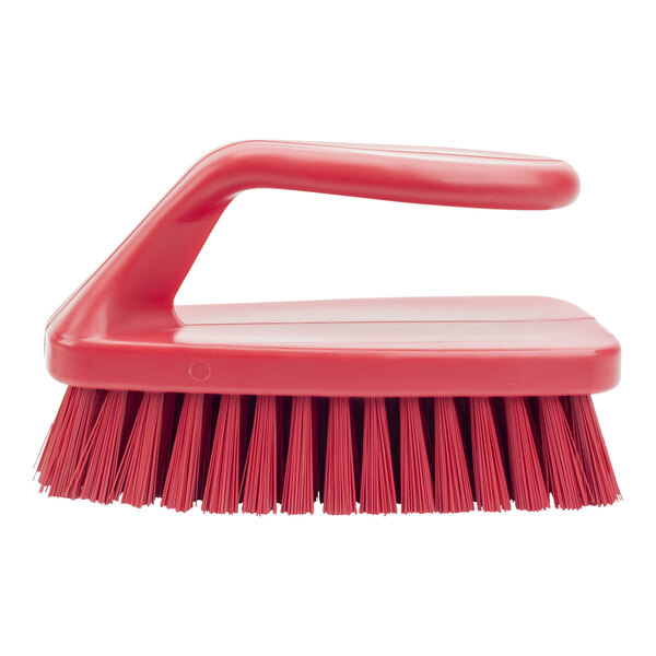 A close-up of a red Carlisle Sparta hand scrub brush with a handle.
