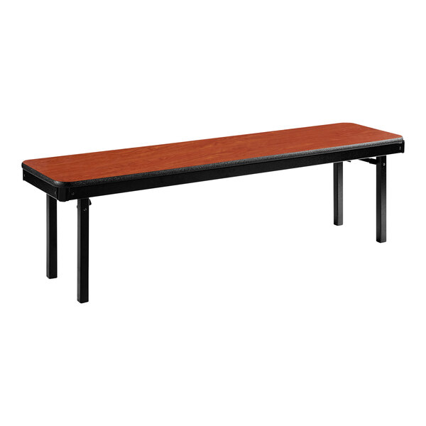 A long wooden bench with black legs and a red top.