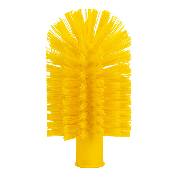 A close up of a yellow Carlisle Sparta pipe and valve brush with bristles.