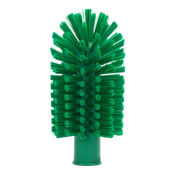 A close-up of a Carlisle green pipe and valve brush with green bristles.