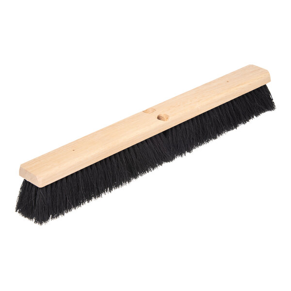 A wooden Carlisle Flo-Pac push broom head with black bristles.