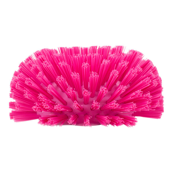 A close-up of a Carlisle pink tank and kettle brush with polyester bristles.