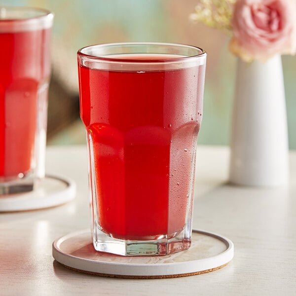 A glass of Hartley's Cranberry Juice on a coaster.