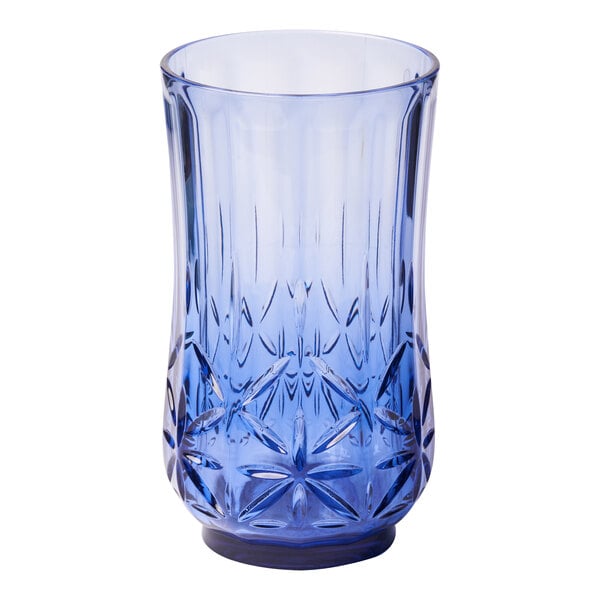 A close-up of a Sophistiplate cobalt blue plastic tumbler with a star pattern.