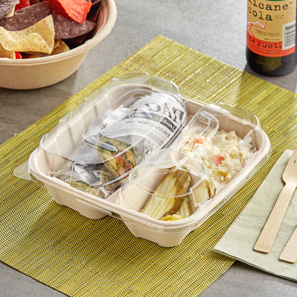 A Stalk Market plastic dome lid on a tray of food with a fork.