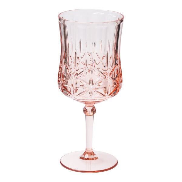 A close-up of a Sophistiplate blush pink plastic wine glass.