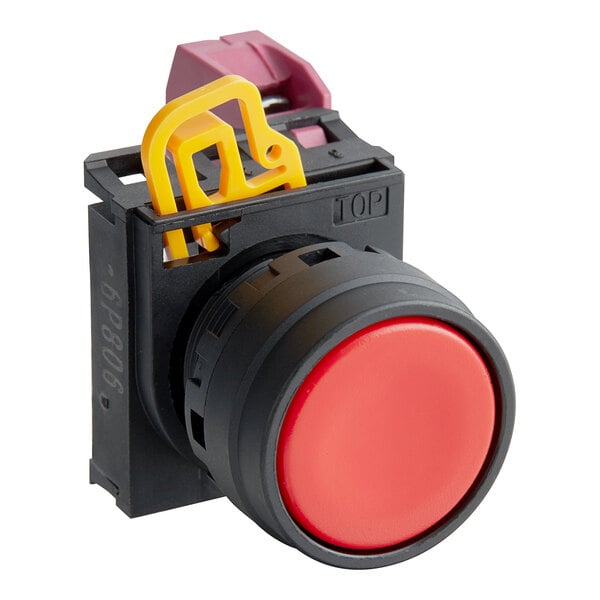A red push button with a yellow plastic object in the middle.