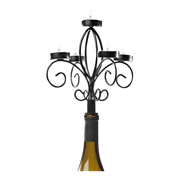 A Franmara black wine bottle candelabra with candles in it.