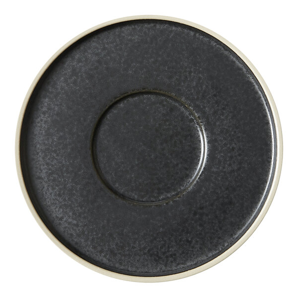 A close-up of a black saucer with a white rim.