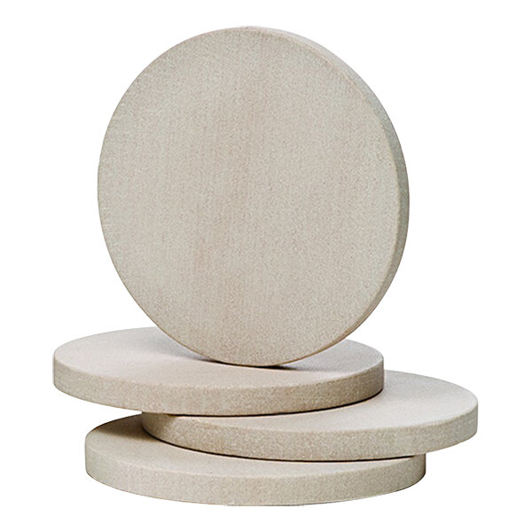 A stack of Franmara round beige sandstone coasters on a white surface.
