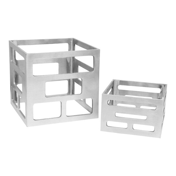 A pair of silver aluminum square nesting risers with holes in them.
