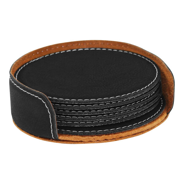 A stack of Franmara black leather coasters with white stitching in a holder on a table.