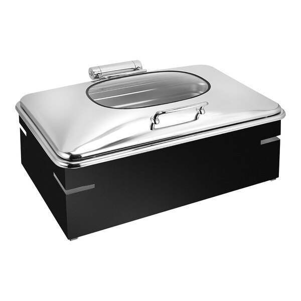 An Eastern Tabletop black and silver chafing dish with a glass lid on a counter.