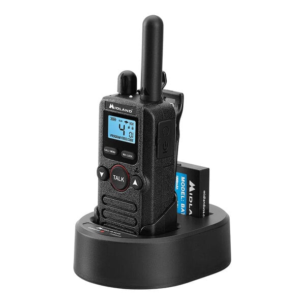 A black Midland BizTalk walkie talkie in a charging station.