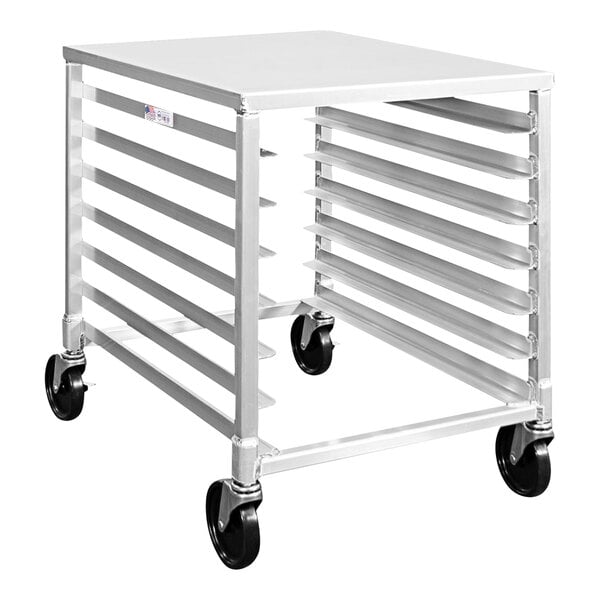 A white metal New Age sheet pan rack with four shelves on black wheels.