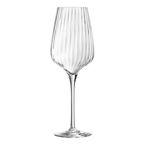 A close-up of a clear Chef & Sommelier wine glass with a curved stem.