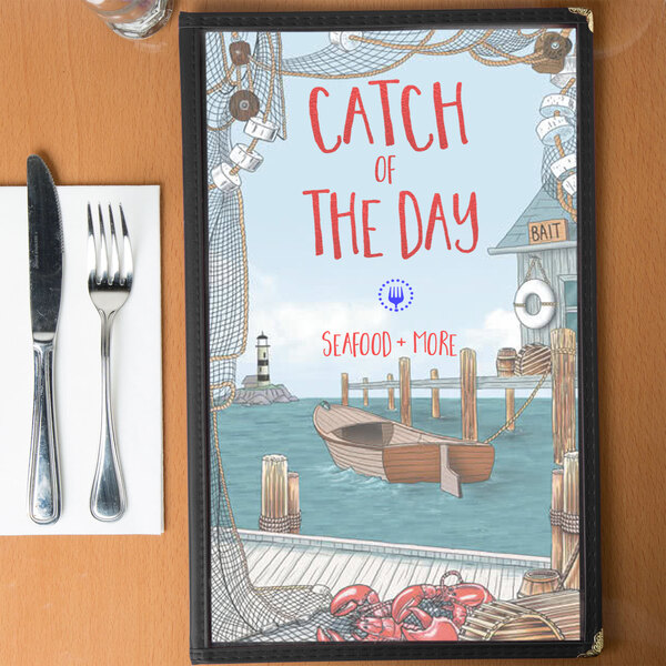 A Seafood Themed menu cover with a boat and fork and knife design on a counter.