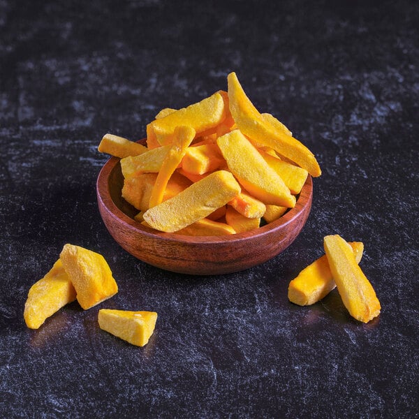 A close up of yellow freeze-dried mango slices.