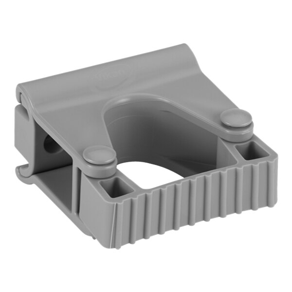 A gray plastic Vikan wall bracket with holes.