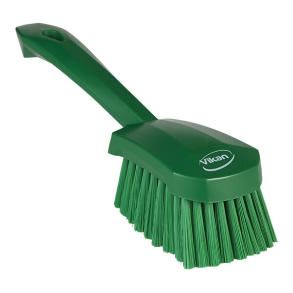 A green Vikan washing brush with a handle.