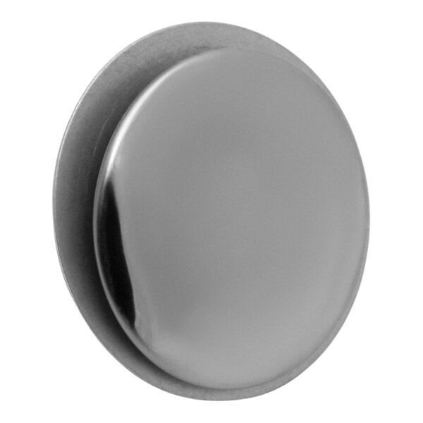 A close-up of a silver round plastic faucet hole cover with a button in the center.