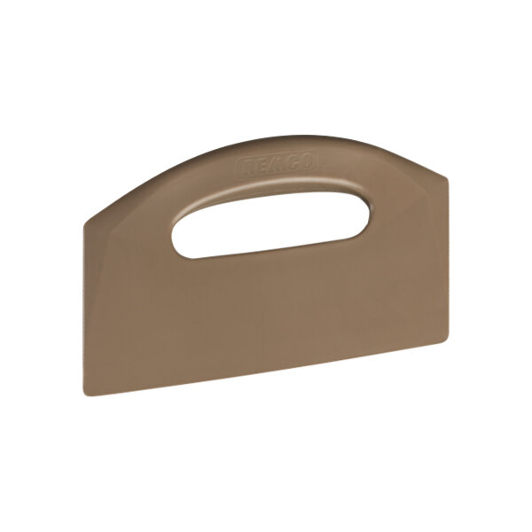 A brown plastic object with a Remco brown plastic handle.