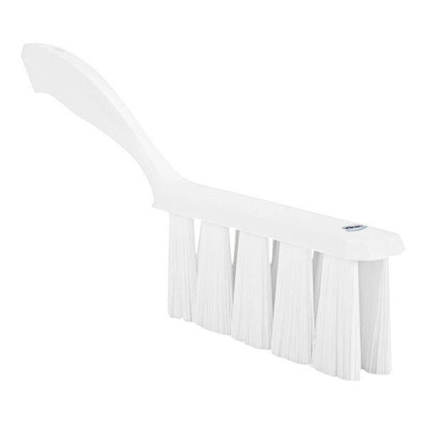 A white bench brush with a long handle.