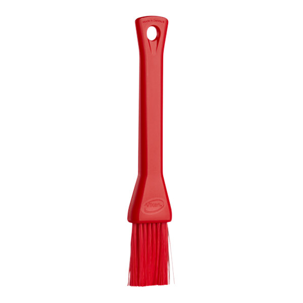 A red brush with a plastic handle.