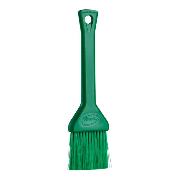 A green brush with a plastic handle.