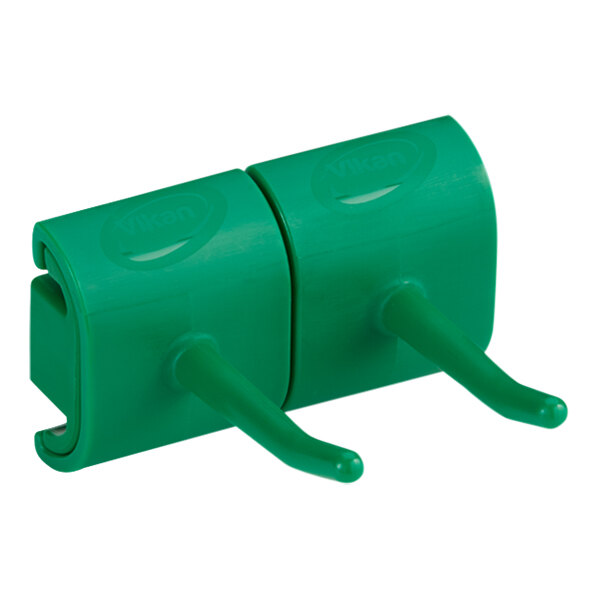 A green plastic Vikan wall bracket with two hooks.