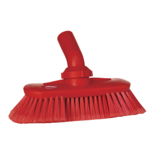 A close-up of a red Vikan water fed deck brush head with soft / split bristles.