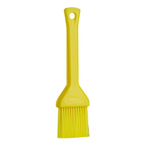 A yellow Vikan pastry brush with a plastic handle.