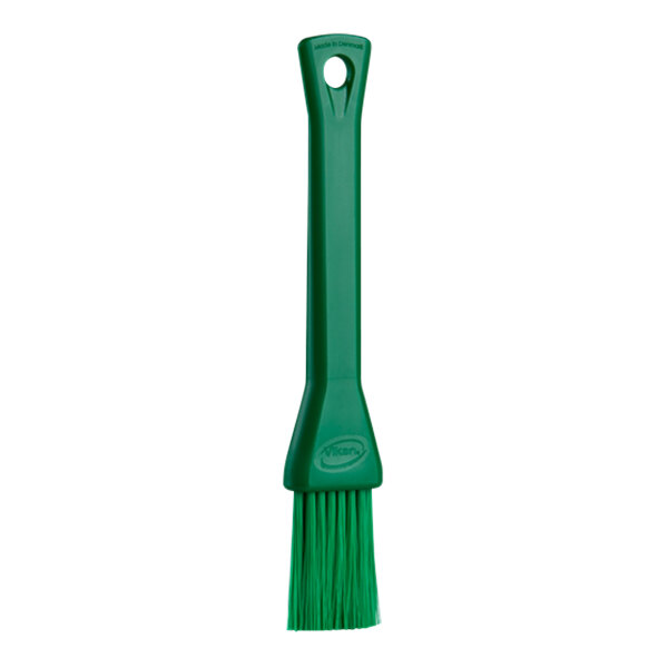 A green Vikan pastry brush with a green plastic handle.