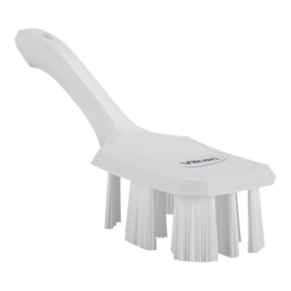 A white Vikan hand brush with a short handle.