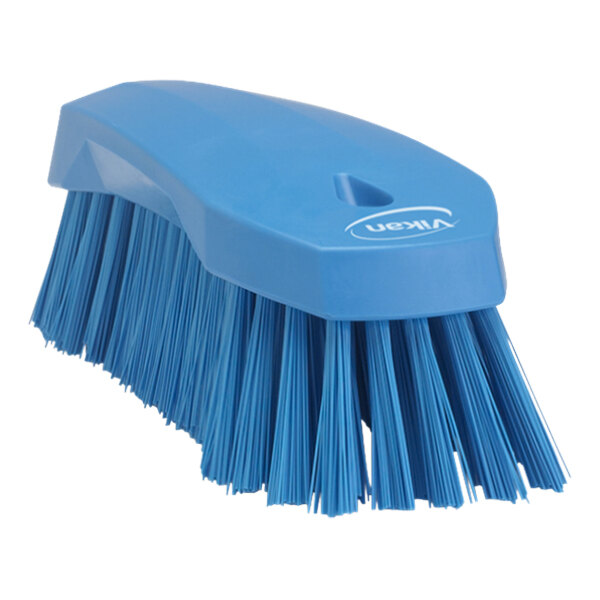 A Vikan blue scrub brush with stiff bristles.