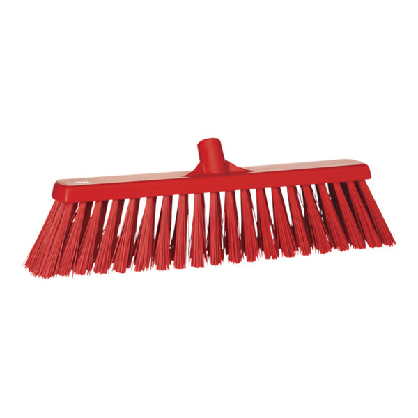 A red broom head with long bristles.