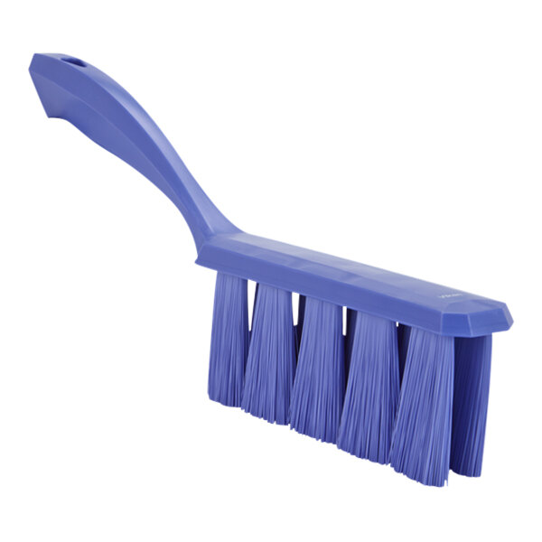 A blue brush with long bristles and a blue plastic handle.