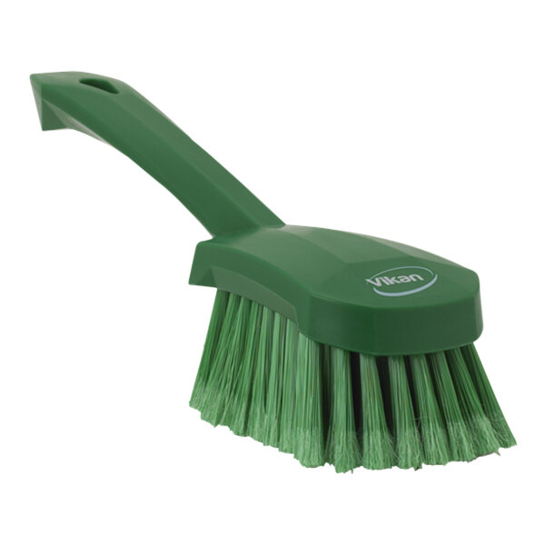 A green Vikan washing brush with a short handle.