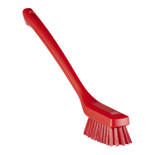 A close-up of a Vikan red narrow brush with long handle.