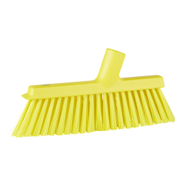 A yellow broom head with long bristles.