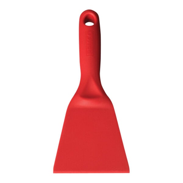 A red Remco hand scraper with a handle.