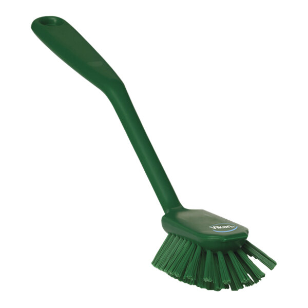 A green Vikan dish brush with a handle.