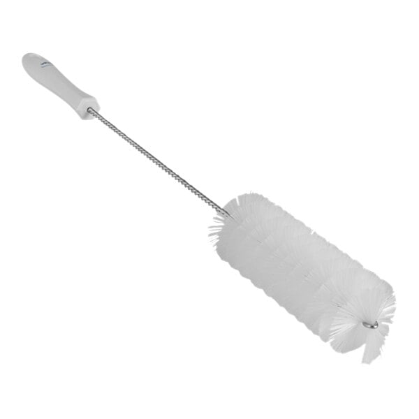 A close-up of a white Vikan tube brush with a long handle.